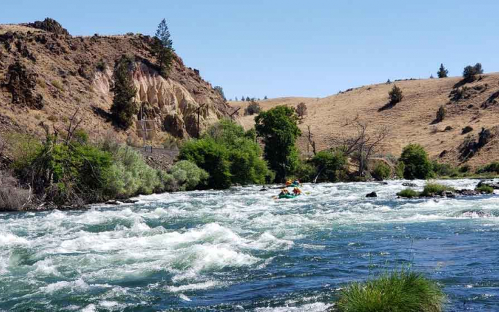 a group of women navigates whitewater on rafting trip with outward bound
